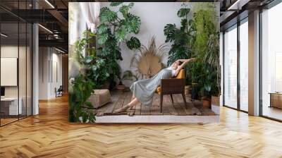 stress relieving plants for home. full-length of carefree dreamy young woman in headphones relaxing  Wall mural