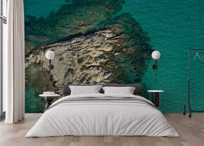 Aerial view of Vourvourou beach, small peninsula in turquoise water of Aegean sea. Waves beating cliff rocky coastline. Halkidiki, Greece. Wall mural