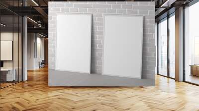 Mock up of two vertical frames on the floor in white interior. Wall mural