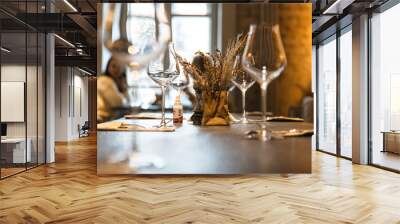 Table in the restaurant on which there are empty glasses and a vase, serving Wall mural