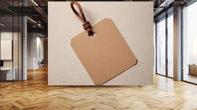 Brown Paper Price Tag With String Isolated on brown background. Wall mural