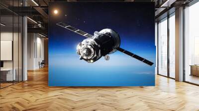 Spaceship on orbit of Earth. Blue planet and Sun light. Space craft in dark space. Expedition to International space station. Elements of this image furnished by NASA Wall mural