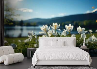 A panoramic view captures white flowers with a bird in flight, featuring a soft focus for depth, while a distant lake and mountains add to the serene backdrop. Photorealistic illustration Wall mural