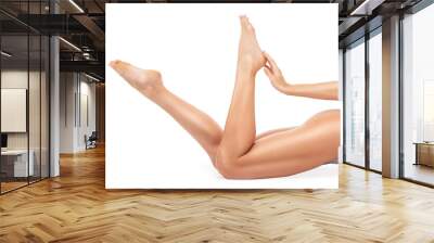 A slender swarthy woman in beige underwear sits on a white floor against a white background. Healthy lifestyle, sport and diet. Wall mural