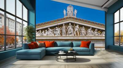 ancient Greek gods and deities statues in Neo classical pediment of the national academy of Athens Greece under clear blue sky, space for text Wall mural