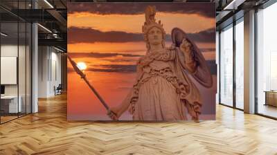 Athena statue the ancient Greek goddess of wisdom and knowledge illuminated by dramatic sun burned sky, Athens Greece Wall mural