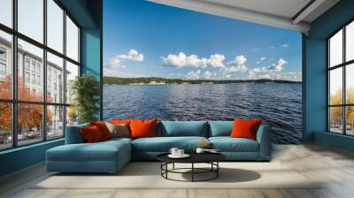 Panorama of calm lake, Kama river blue sky with clouds reflected in the water. Wall mural