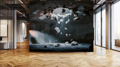 Mystery dark room with a hole in the ceiling and falling rocks Wall mural