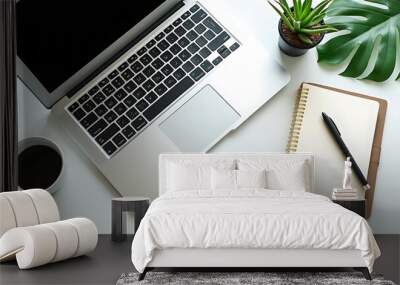 Office desk with a white table featuring a blank notebook computer supplies and a coffee cup Top view with space for text Flat lay composition Wall mural