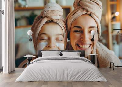 Mom and her daughter having fun together, making clay facial mask and wearing bathrobes. Mother with child doing beauty treatment together. Family time, spa and beauty, mothers day Wall mural