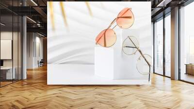 Sunglasses and glasses sale concept. Trendy sunglasses on podiums on a white background. Trendy Fashion summer accessories. Copy space for text. Promotion, sale. Optic store discount poster. Minimal Wall mural