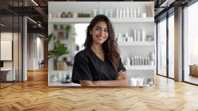 smiling hispanic diverse female receptionist at beauty salon or sales person at cosmetics store at reception desk Wall mural