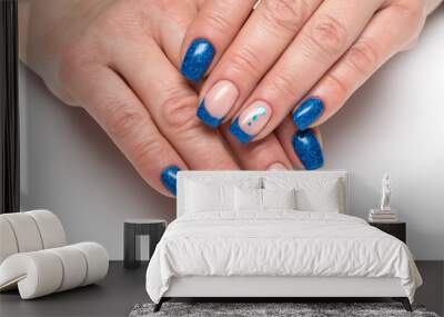 blue french manicure with blue sparkles on long square nails with shiny candy on a white background close-up
 Wall mural