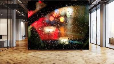 Lights of night city through the glass of the car with raindrops Wall mural