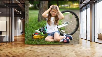 The girl was injured while riding a bike in the summer. Wall mural