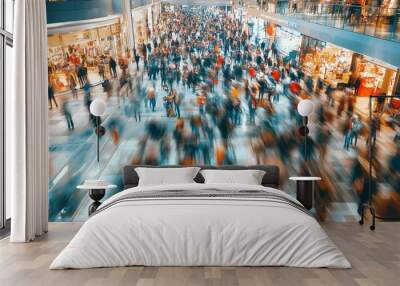 A blurred image of a busy shopping mall, with people moving in all directions. Wall mural