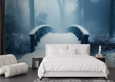 A wooden bridge covered in snow leads into a misty forest. The trees are bare and the air is still. The scene is peaceful and serene. Wall mural