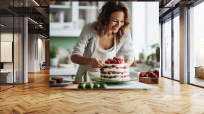 Homemade pastry shop. Happy young female pastry chef preparing a delicious birthday cake in the kitchen.  Wall mural