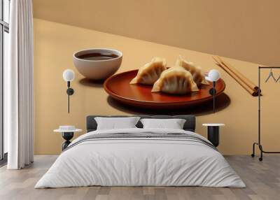 Minimal composition with tasty dumpling and bowl of soy sauce, flat beige background. Chinese dumplings with Japanese chopsticks.
 Wall mural