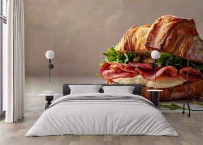 Toasted Croissant Sandwich with Salami and Mozzarella. Gourmet croissant sandwich with salami, mozzarella cheese, and fresh arugula on a flat background. Wall mural