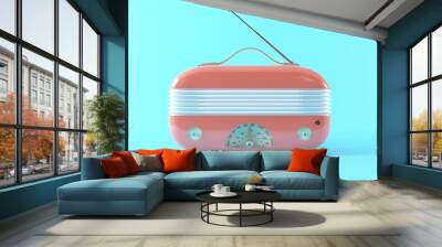 Vintage plastic pink radio with antenna. Trending radio receiver on a pastel blue background, isolated, front view. Retro music technology concept. 3d render illustration. Wall mural