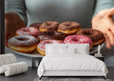 Woman refuses to gesture away from the plate of donuts, pushing it away from her. Refusal of unhealthy caloric food Wall mural