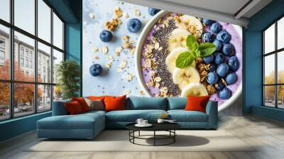 Сlose-up of a healthy vegan breakfast. A plate with healthy superfood - fresh berries, fruit yogurt, chia seeds, granola and banana slices on pastel table.  Wall mural