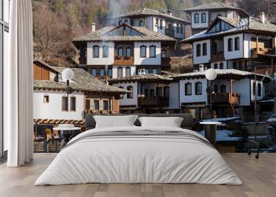 Buildings of traditional style in the village of Leshten in Bulgaria during winter Wall mural