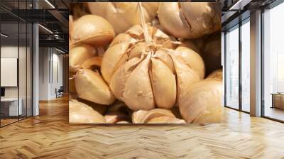 A collection of garlic ready to be sold and purchased at a modern market. Organic garlic harvest. Wall mural