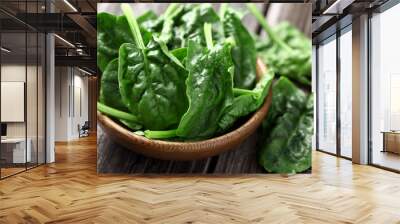 Spinach leaves in a wooden plate Wall mural