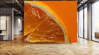 A close-up of a fresh orange slice against a vibrant orange background. Wall mural