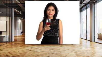 Portrait of a cheerful young woman holding a glass of wine isolated over white background Wall mural