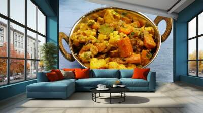 Mixed vegetable curry in a dish on a wooden blue background, with copy space. Wall mural