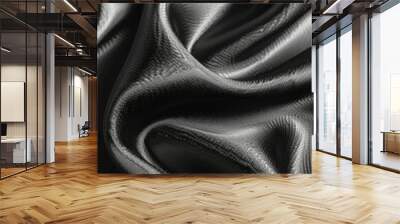 The smooth, black fabric is elegantly arranged in flowing folds, revealing its rich texture and subtle sheen. Light plays across the surface, enhancing its luxurious appearance. Wall mural