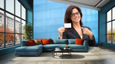 Businesswoman showing business card outside Wall mural