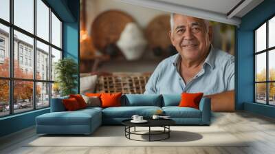 copy space, stockphoto,confident senior hispanic man posing sitting in the living room. single mature senior in living room. Happy woman sitting. Carefree lifestyle. Aged woman in good health. Wall mural