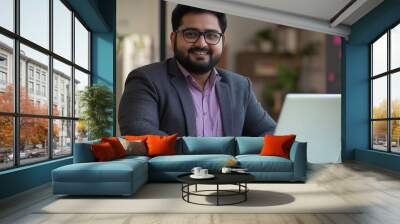 Plus size indian businessman in an office, working at laptop. Indian manager in his office, using a computer. modern office environment , business related banner. Heavy weight businessman body inclusi Wall mural