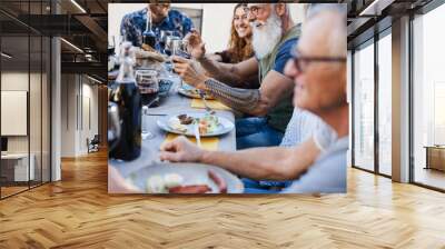 Family people eating at barbecue dinner outdoor - Focus on senior hand holding glass of wine Wall mural