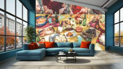 Group of happy friends eating and drinking beers at barbecue dinner in backyard garden - Focus on center table - Summer lifestyle, food and friendship concept Wall mural