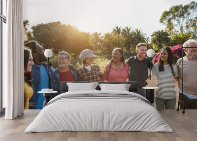 Group of multigenerational people hugging each others - Support, multiracial and diversity concept - Main focus on senior african woman face Wall mural