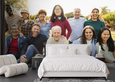 Group of multigenerational people smiling in front of camera - Multiracial friends of different ages having fun together - Main focus on asian center girl face Wall mural