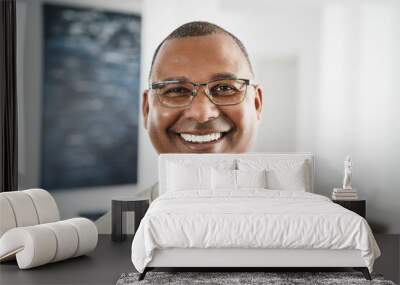 Happy african man looking at camera indoors at home - Focus on face Wall mural