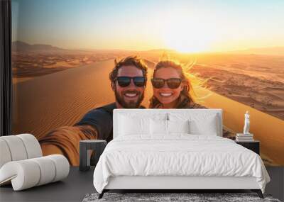 Happy couple taking a selfie on top of a giant desert sand dune at sunset - Travel, holiday and tourism concept - Models by AI generative - Focus on the faces Wall mural