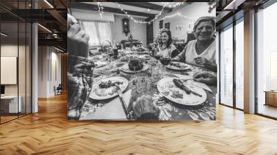 Happy family eating on holiday day - Grandparents, children and parents having dinner - Food and celebration concept - Focus on grandmother face - Black and white editing Wall mural