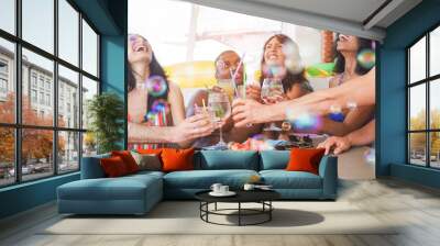 Happy friends cheering with tropical cocktail in boat party with soap bubbles in the air - Young people having fun in summer vacation - Youth, friendship and holiday concept - Focus on close-up  hands Wall mural