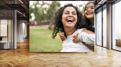 Happy indian mother having fun with her daughter outdoor - Family people and love concept - Focus on mum face Wall mural