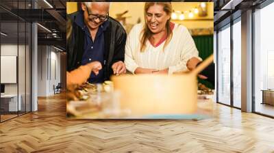 Happy latin family cooking together during dinner time at home - Focus on grandmother face Wall mural