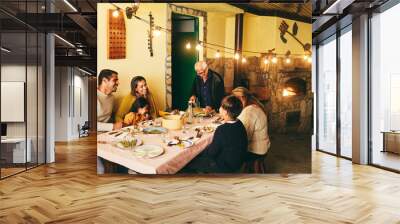 Happy latin family cooking together during dinner time at home - Soft focus on grandfather face Wall mural