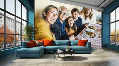 Happy latin family doing selfie while eating together at home - Focus on mother face Wall mural