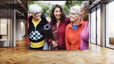 Happy multi generational women having fun together after yoga sport session outdoor - Focus on center girl face Wall mural